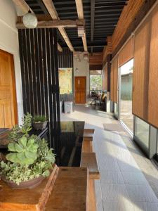 a lobby with a table and potted plants at 傳說民宿 Legend in Fenqihu