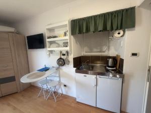 a small kitchen with a sink and a counter at Guest House Kvartin in Umag