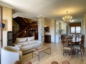 a living room with a white couch and a table at Casa Rural el Cedro in Abejar