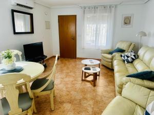 a living room with a couch and a table at Relax Inn in Pilar de la Horadada