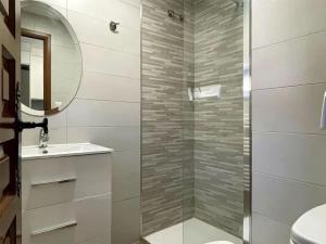 a bathroom with a shower with a sink and a mirror at Casa Rural el Cedro in Abejar +31 photos