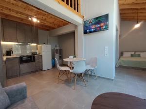 a kitchen and dining room with a table and chairs at River Houses Molyvos in Mythimna