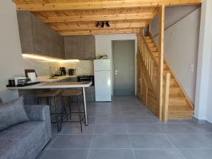 a kitchen with a table and a kitchen with a staircase at River Houses Molyvos in Mythimna +10 photos