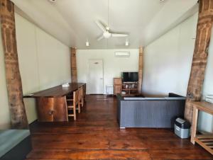 an empty room with a desk and a table at Sumba Retreat Kerewe in Waikabubak