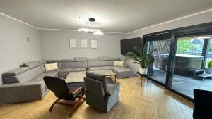 a living room with a couch and a table at Stodoła przy deptaku in Ujsoły