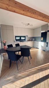 a kitchen with a table and chairs in a room at Stodoła przy deptaku in Ujsoły