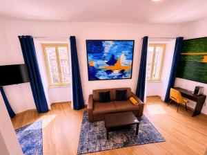 a living room with a couch and a painting on the wall at Baglioni Art Suite in Perugia