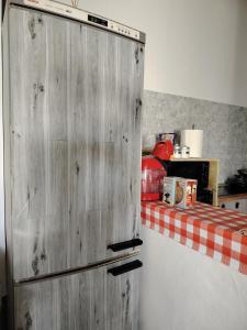 a wooden refrigerator in a kitchen with a table at Casa adosada con patio in Jerez