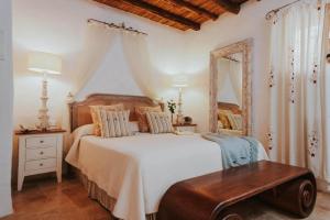 a bedroom with a large bed and a mirror at Can Pardal in Sant Miquel de Balansat +62 photos