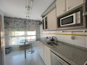 a kitchen with a sink and a microwave at TXIMELETA Haro in Haro