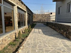 a stone walkway next to a brick building at Garden Guesthouse in Yerevan