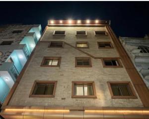 a tall building with many windows at night at hotel darbar international in Gaya