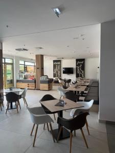 a restaurant with tables and chairs in a room at BeWell Apartment in Zalakaros