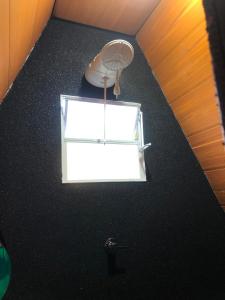 a room with a window and a lamp on the floor at Chalé estilo in Chapada dos Guimarães