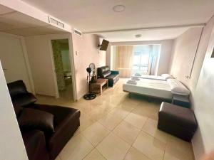 a living room with a bed and a couch at Hostal Alegria Alicante in Alicante +25 photos
