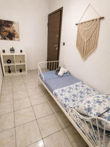 a bedroom with a bed and a tiled floor at Oasis Pool Flat-near 2 metro stations- in Piraeus +11 photos
