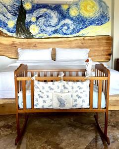 a bedroom with a bed with a painting on the wall at Cinema & Gaming House with View in Skotina