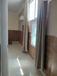 a bathroom with a window and a shower curtain at La Perle De Briech in Asilah +60 photos