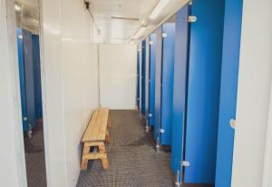 a hallway with a wooden bench in a locker room at Leto Shepherds Hut By Airpremier in Alfriston