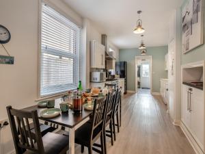 a kitchen and dining room with a table and chairs at Samphire in Bacton