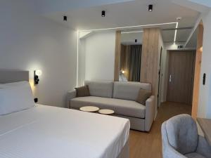 a hotel room with a bed and a couch at Local Urban Living in Volos