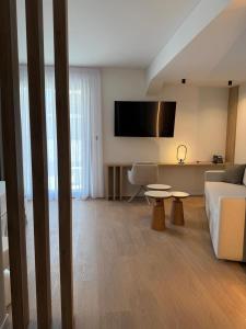 a living room with a couch and a table at Local Urban Living in Volos