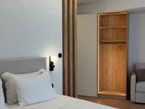 a bedroom with a bed and a wooden door at Local Urban Living in Volos