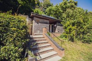 a set of stairs leading to a small building at Leto Shepherds Hut By Airpremier in Alfriston