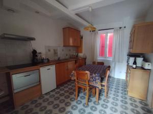 a kitchen with a table and chairs in a room at Brimborion in Alba-la-Romaine +11 photos