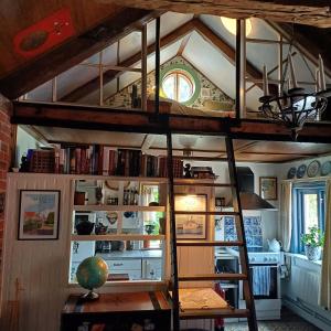 a room with a loft bed and a kitchen at Villagatan in Hjo