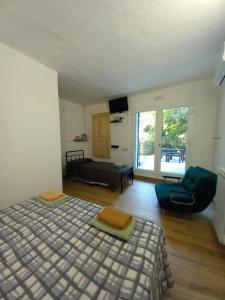 a bedroom with a bed and a couch and a chair at Agriturismo U muinettu in La Spezia