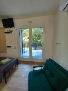 a living room with a couch and a large window at Agriturismo U muinettu in La Spezia