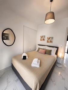 a bedroom with a large bed and a mirror at Skyloft Meteora 1 in Kalabaka