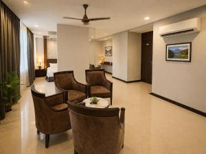 a hotel room with chairs and a table and a bed at BHAGYA SHREE Hotel in Nokha