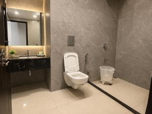 a bathroom with a toilet and a sink and a mirror at BHAGYA SHREE Hotel in Nokha