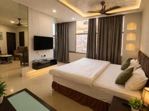 a bedroom with a large bed and a living room at BHAGYA SHREE Hotel in Nokha