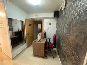 an office with a desk and a computer on a wall at Hostal Alegria Alicante in Alicante