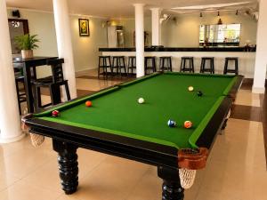 a pool table with balls on it in a room at Abode Hotel Siem Reap in Phum Pobos