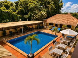 an overhead view of a swimming pool with chairs and a house at Abode Hotel Siem Reap in Phum Pobos