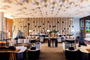 a hotel lobby with couches and tables and a striped wall at Hua Hin Marriott Resort and Spa in Hua Hin
