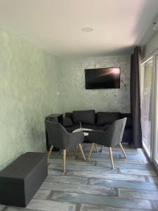 a living room with a couch and a table and chairs at MAX Dunaj in Trstice