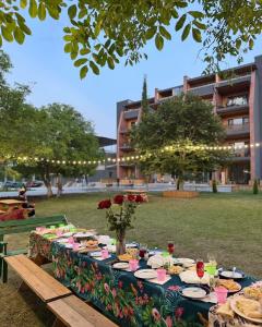 a long table with food on it in a park at Bazaleti Lake Escape in Bazalet'i