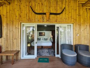 a bedroom with a bed with an antler on the wall at Sumba Retreat Kerewe in Waikabubak