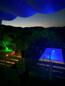 a view of a swimming pool at night at Elatovillage in Elatochori