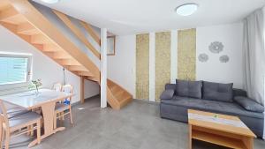 a living room with a couch and a table at Villas Corinthia in Baška