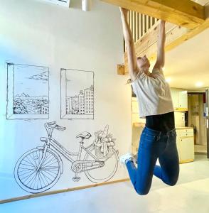 a person jumping in the air with a bike on a wall at Lavender Circus Hostel, Doubles & Ensuites in Budapest