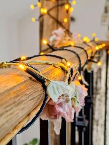 a row of lights on a pole with flowers at Rosie's Barn in Penrith