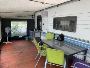 a kitchen with a table and chairs in a trailer at Helska Ostoya in Hel