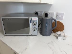 a kitchen counter with a microwave and a coffee maker at Cosy apartment - Na Creagáin in Tully +26 photos