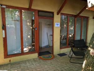 a screened in porch of a house with windows at B59 mini in Budakalász